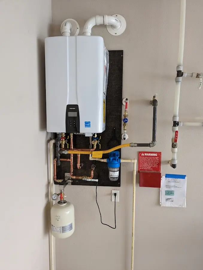 Professional plumber installing copper piping in a Claymont home